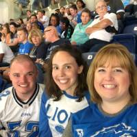 Three people smiling at the football game